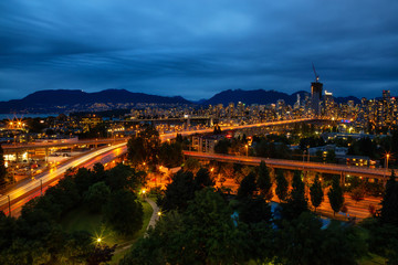 Obraz premium Aerial view of Downtown City during a cloudy summer night after sunset. Taken in Vancouver, British Columbia, Canada.