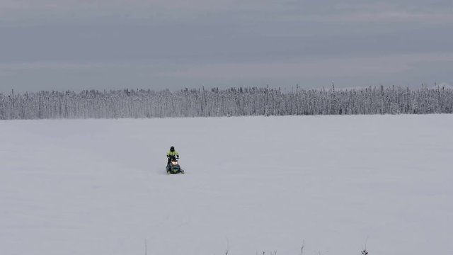 Snowmobile traveling across frozen field towards camera, Anchorage 4k