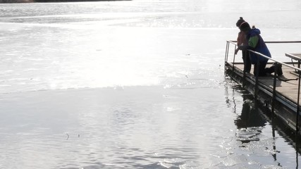the beginning of spring. children play near the water.