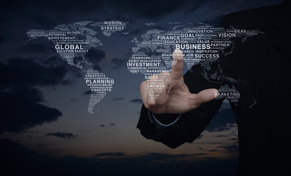 Businessman pressing global business words world map over sunset sky, Elements of this image furnished by NASA