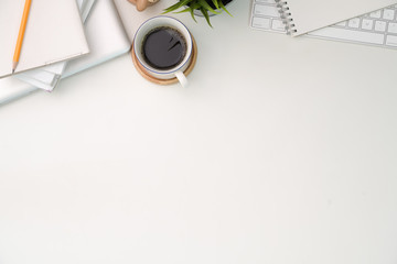 Workspace with computer, keyboard, coffee and copy space