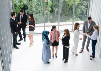 Many business people gathering in modern office building for business conference in the city....