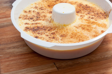 home made vanilla and cinnamon flan over a wooden table