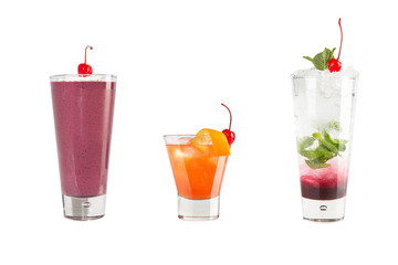 A variety of alcoholic drinks, beverages and cocktails on a white background. Three different drinks with maraschino cherries.