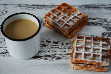 Tasty breakfast, delicious fresh Viennese waffles and cup of coffee on wooden background