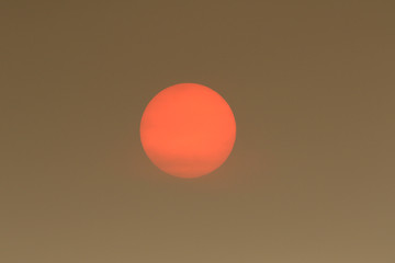 The Sun colour in the Uk was due to a weather phenomenon, Saharan dust, blown in by ex-hurricane Ophelia and also from debris, caused by fires in Portugal and Spain.