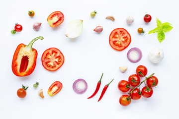 Various fresh vegetables and herbs on white background.