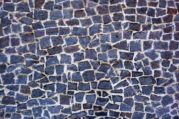 The texture of the wall of expensive large dark stones
