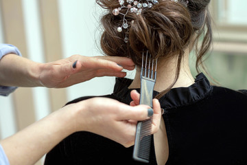 Young woman is getting a haircut at a salon