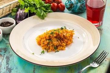 cabbage stew on white plate served on blue wooden table table for lunch