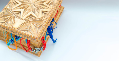 wooden box with oriental patterns. Jewelry box full of beads and beads. selective focus