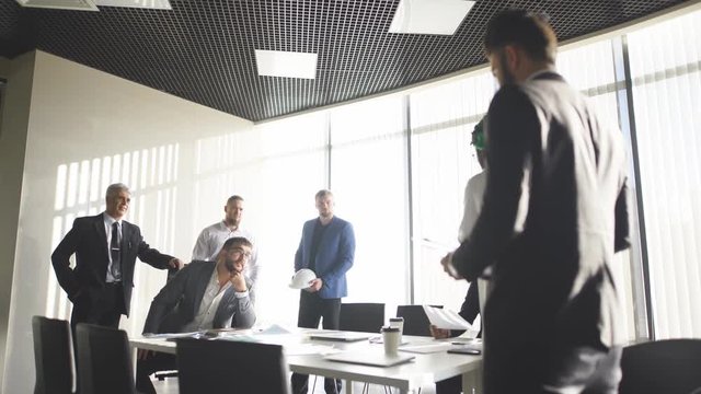 Interracial partners arguing during team building training meeting, Caucasian outrageous office worker disagreeing with Arabian colleague, dark-skinned and white businessmen disputing at negotiations