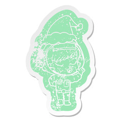 cartoon distressed sticker of a pretty astronaut girl wearing santa hat