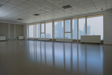 Fototapeta na wymiar Beautiful view from modern large windows in spacious empty room