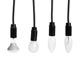 Set of different hanging lamp bulbs with wires on white background