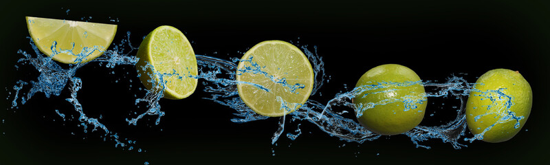 tasty fruit - lime in water on an isolated green and black background