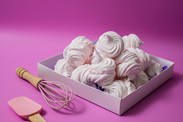 white homemade zefir or marshmallow on pink background  