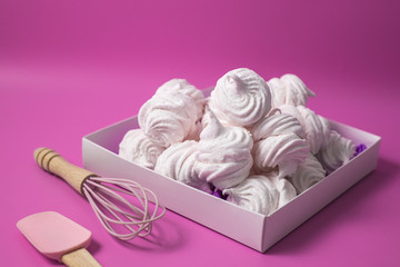 white homemade zefir or marshmallow on pink background  