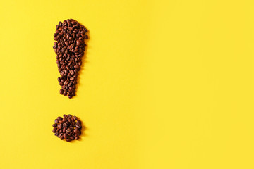 Coffee grains lying in the shape of exclamation mark