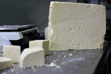 Blocks of traditional fresh soft white Colombian cheese in a market in Colombia, South America