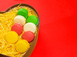 Macaroons in a gift box. Heart-shaped box. Copy space.