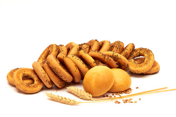 Homemade bagels with poppy seeds - bread products with wheat flour, wheat ears of wheat and grains are the harvest of a person's work