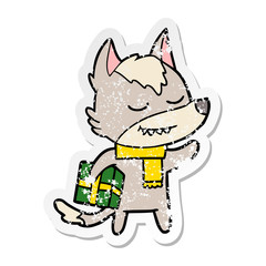 distressed sticker of a friendly cartoon wolf carrying christmas present