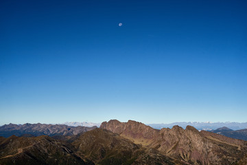 Fototapeta premium Moon over Lagorai Mountains chain, Primiero, Trentino, Italy 