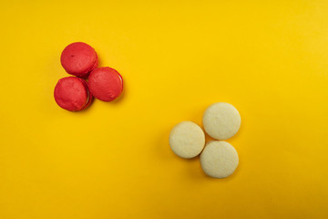 Colorful macaroons on a yellow background. Concept for the holiday. Copy space