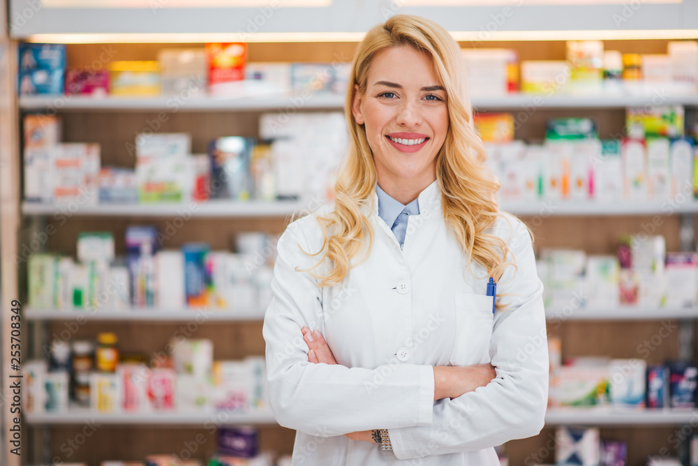 Wall mural Medicine, pharmaceutics, healthcare and people concept. Portrait of a happy female pharmacist.