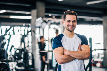 The athlete smiling at camera and is happy with his workout.