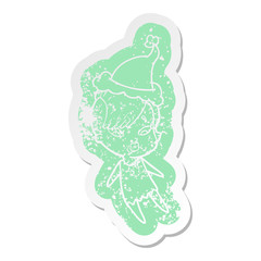cartoon distressed sticker of a surprised girl wearing santa hat