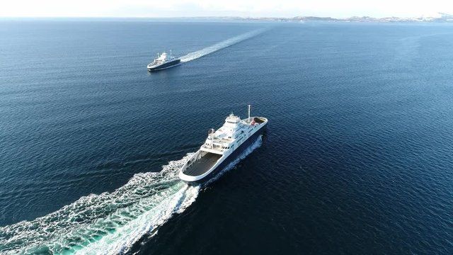 Aerial footage of a ferry departing, passing another ferry, transition to the arriving ferry Part 5