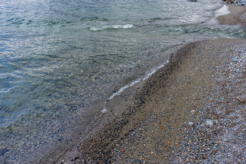Italy, Varenna, Lake Como, HIGH ANGLE VIEW OF SURF ON BEACH