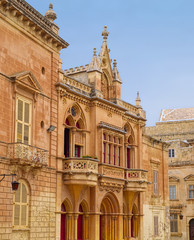 Fototapeta na wymiar Typical yellowish tones of medieval architecture in the historic city of Mdina, Malta.