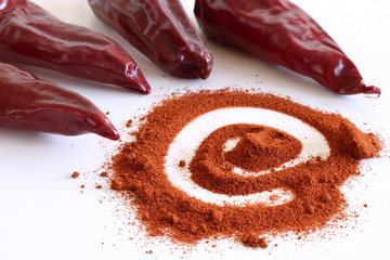 Red pepper chili Piment d'espelette and pile of red powder isolated on white background.Food concept.
