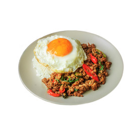 Rice topped with stir fried pork and basil on white background.