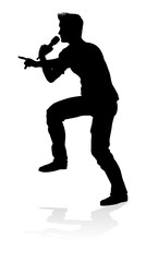 A singer pop, country music, rock star or hiphop rapper artist vocalist singing in silhouette