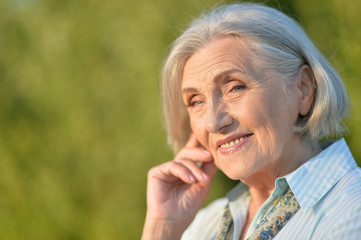 Portrait of beautiful elderly woman posing outdoors