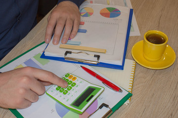 Close up view of bookkeeper or financial inspector hands making report, calculating or checking balance. Home finances, investment, economy, saving money