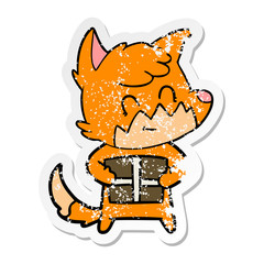 distressed sticker of a cartoon friendly fox with gift