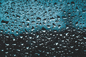 Raindrops on blue background window
