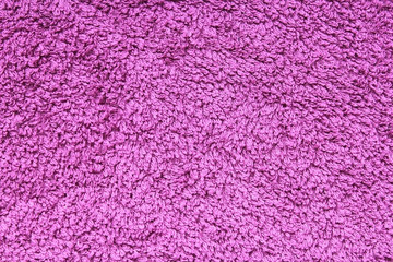 Purple texture shaggy towel background. Structure of a blue cotton towel.