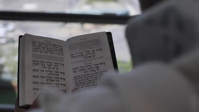 Hebrew text Modhe Ani morning prayer. Pray letters from Jewish Torah Bible Old Testament Ancient Text. Spiritual religious text kabbalah close up shot