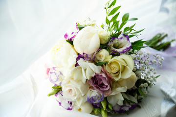 A bouquet of flowers for the bride lies on the green grass