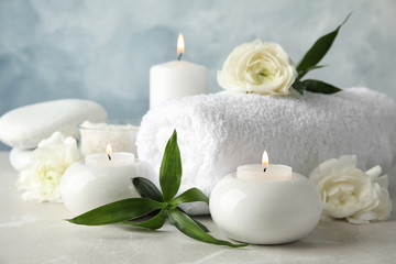 Beautiful spa composition with candles and flowers on table