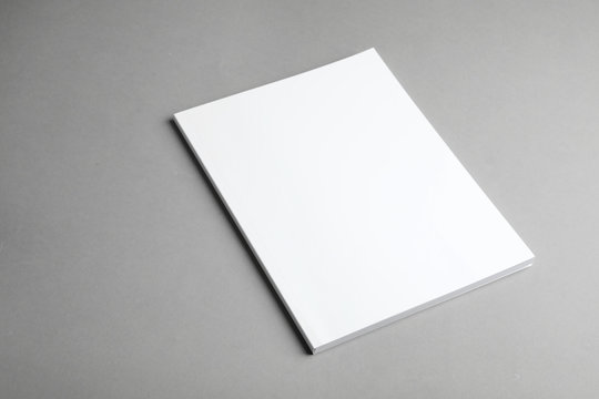 Brochure with blank cover on grey background. Mock up for design