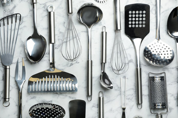 Different kitchen utensils on marble background, flat lay - Powered by Adobe