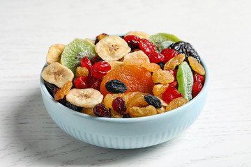 Bowl with different dried fruits on wooden background. Healthy lifestyle