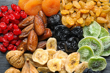 Different dried fruits on wooden background, top view. Healthy lifestyle